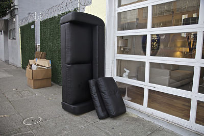 black sofa for junk pick up by curbside in long beach california